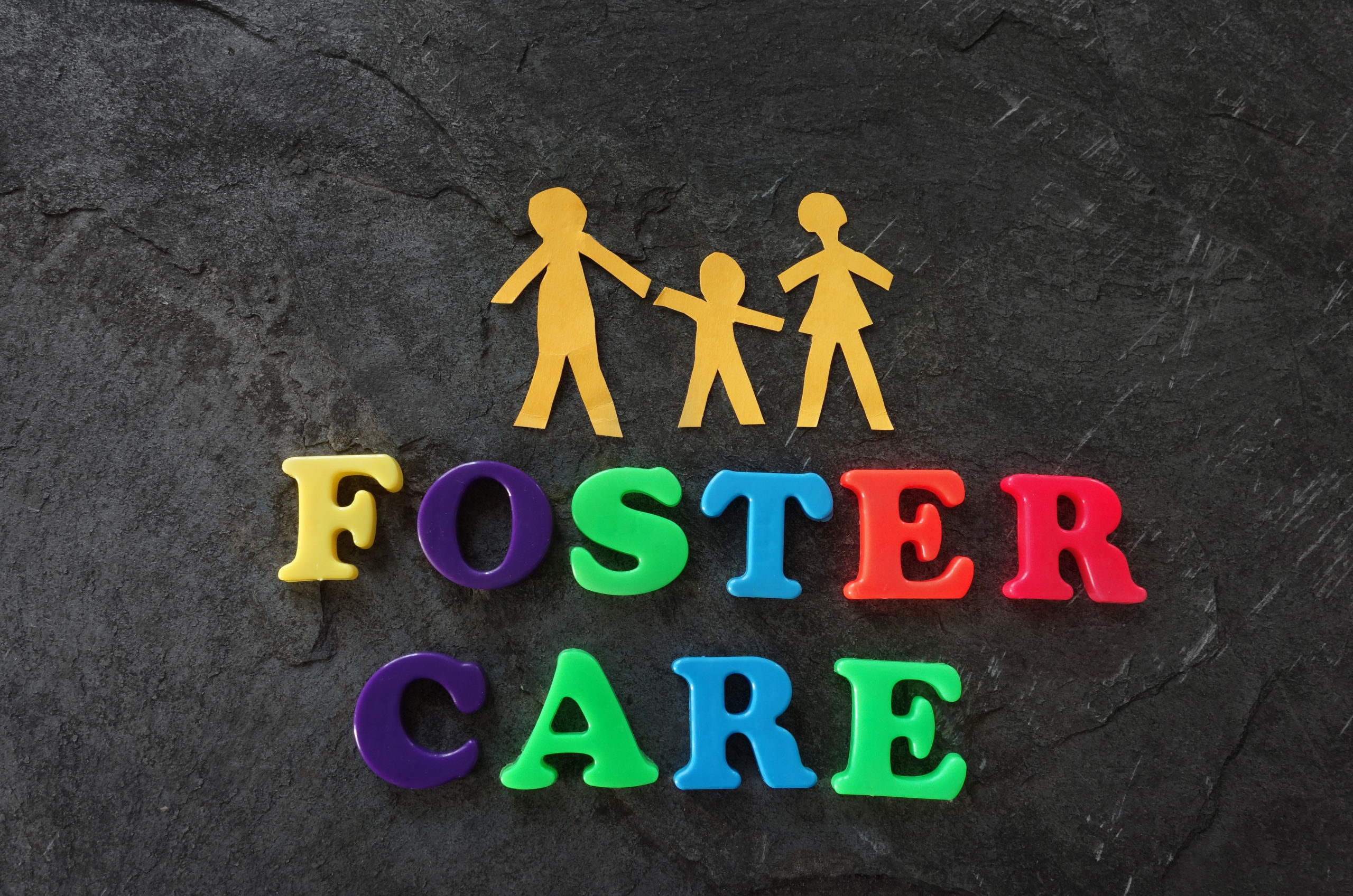 Paper family with Foster Care letters